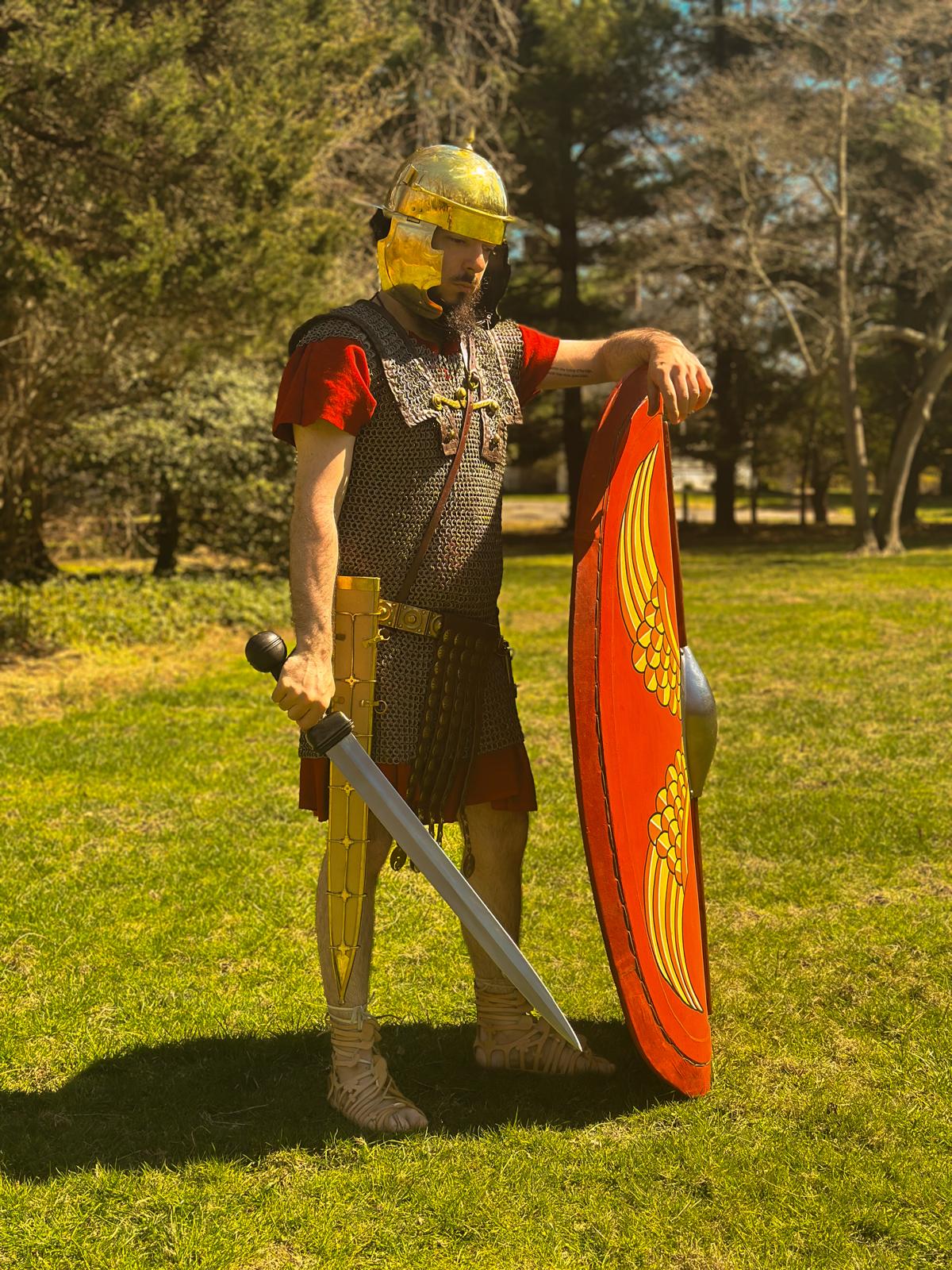 A late Republic Roman legionary leaning on his shield, his sword by his side, staring at the ground